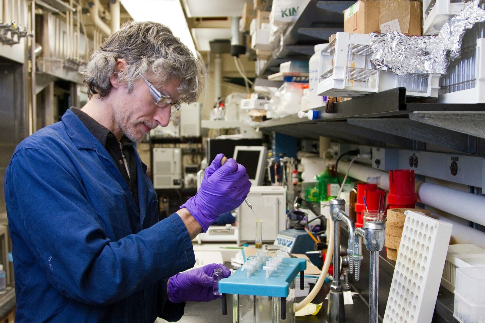 A veterinary technician analyzing enzyme activity using specialized equipment
